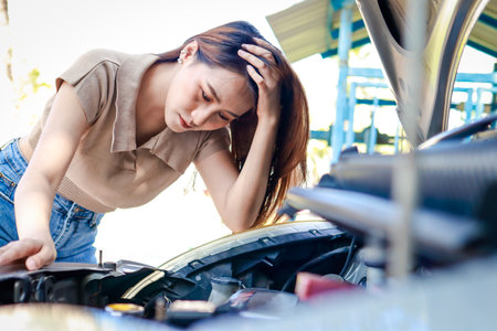 Stressed beautiful Asian woman car broken down on the side of the road There is a problem with the...