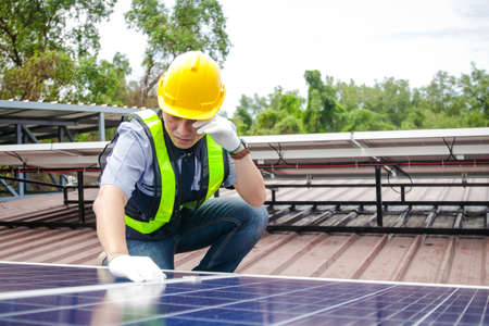 Asian technicians install panels Solar cells to produce and distribute electricity. Energy technology concept.の写真素材