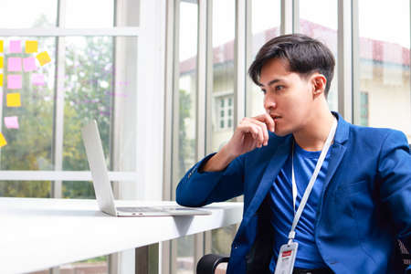 Asian business men sitting in the office Viewing stock trading data on a laptop computer. Asset investment concept. Brokers, investment platforms. online tradingの写真素材