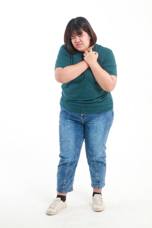 Obese Asian women with left chest angina are at risk for coronary artery disease. standing on a white background. health care conceptの写真素材