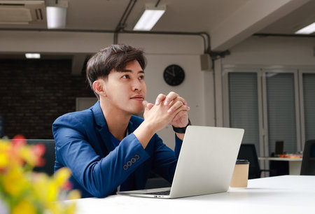 Asian business men sitting in the office Smile and enjoy working. Manager of Finance and Marketing Projects. Entrepreneurial concept.の写真素材