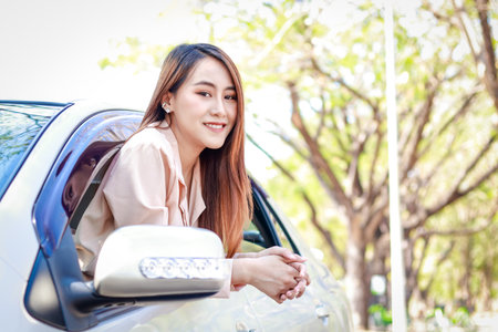 Beautiful smiling Asian woman enjoying her driving. Transportation concept. car insurance safetyの写真素材