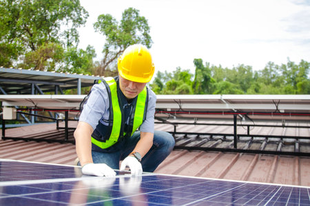 Asian male electrical engineer Supervise and supervise the installation of solar cell systems for customers on the factory roof. business concept solar energy or solar systemの写真素材