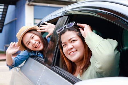 two asian women travel by car Happy smile. Tourism concept. Transportation, travel by private car. Outdoor adventure travel. car insuranceの写真素材