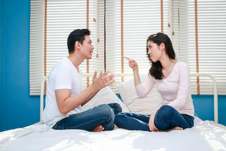Family concept. Asian couple arguing in bed Feeling unhappy in a married life. couple problemsの写真素材