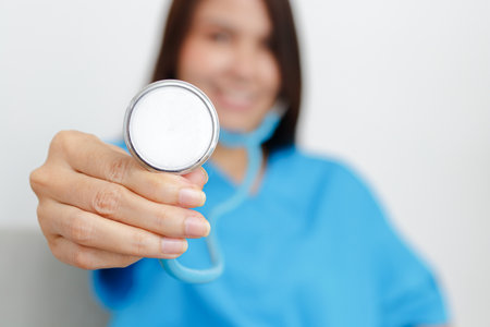Asian female doctor holding a stethoscope to examine the patient's symptoms. concept of medical services in a hospitalの写真素材