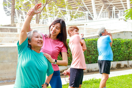 Asian family exercising outdoors in the morning They smile happily. Sport concept, fitness family, health care.の写真素材