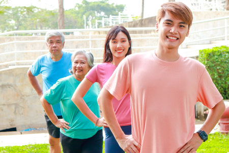 Portrait of a group of people exercising outdoors in the morning They smile happily. Sport concept, fitness family, health care.の写真素材
