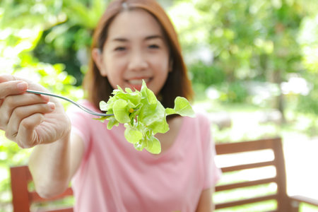 Healthy Asian woman eating vegetable salad. Healthy food concept, weight lossの写真素材