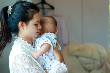 Portrait of an Asian mother Holding a baby boy in her arms. Family concept. copy spaceの写真素材