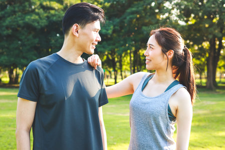 Asian couple exercising together in the park in the morning They are strong and healthy. outdoor exercise concept, healthcareの写真素材