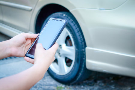 Car insurance concept. A woman driving an accident uses a smartphone to take a picture of the car. transportationの写真素材