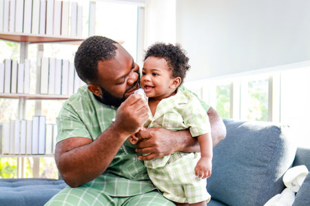 Portrait of a happy African American father and son in the house. Family concept.の写真素材