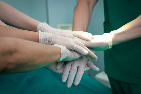A team of professional surgeons work together in the operating room to treat patients. medical services in hospitalsの写真素材