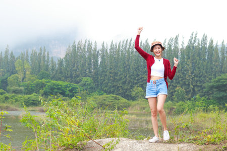 Asian female tourists enjoying the trip Standing in the wild nature. Travel concept. hiking adventure. copy spaceの写真素材