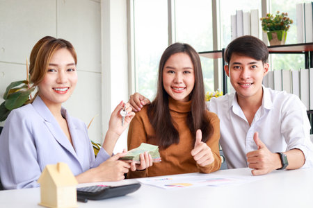 Asian couple buying a house with a real estate agent. Family concept. Moving to a new home or renting propertyの写真素材
