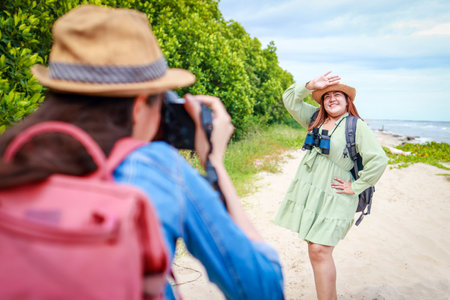 Asian tourist nature tourism standing on the beach taking pictures. Ecotourism.の写真素材