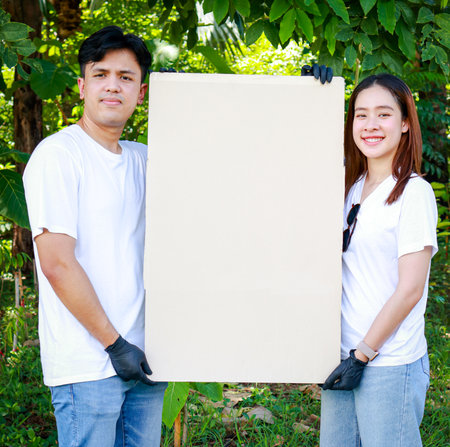 Group of young Asian volunteers to support nature and the environment Holding a brown paper sign, blank space for writing a message. Social volunteer concept. world environment dayの写真素材