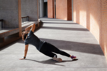 Asian woman exercising in the morning sitting stretching Before and after exercising on concrete...