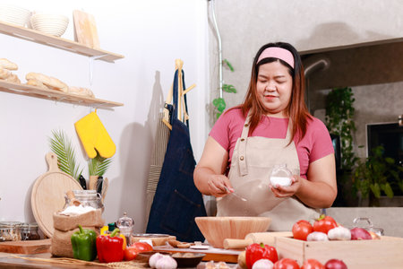 Making pizza in a traditional Italian style. Asian female chef making pizza in the kitchen.の写真素材