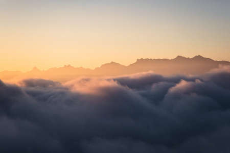 Panoramic view of alpine mountain range above clouds in Alpstein alps Appenzell Switzerland
