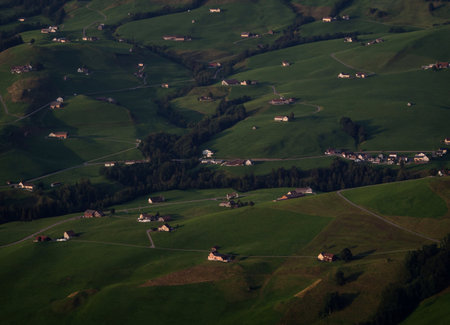 Idyllic isolated farm buildings in pictureque Alpstein Appenzell mountain hills landscape...