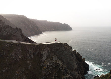 Aerial panorama of Cabo Ortegal lighthouse on steep rocky cliff atlantic ocean bay of biscay Carino Cape Galicia Spainの写真素材