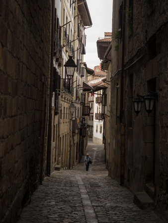 Old historical buildings facades in narrow cobblestone streets alley lane in Hondarribia Fuenterrabia Basque Spainの写真素材