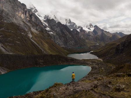 Male yellow jacket hiker Cordillera Huayhuash Circuit andes mountain Mirador Tres Lagunas three lakes view Huanuco Peruの写真素材