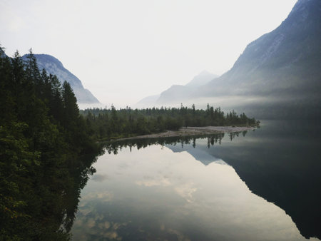 Panorama reflection of alpine mountain lake Konigssee Koenigssee King Schonau Berchtesgaden Bavaria...