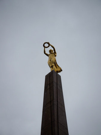 Closeup view of historic war memorial monument of remembrance golden lady statue sculpture Gelle Fra in Luxembourgの写真素材