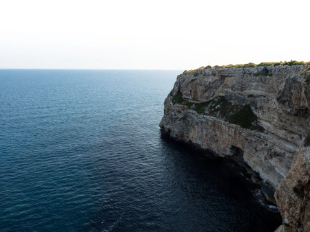 Panorama view of rocky cliff coast shore turquoise mediterranean sea water Cala Llombards Mallorca...