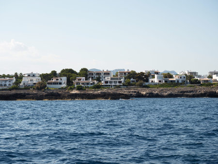 Panoramic seascape rocky cliffs coast shore view luxury holiday homes white apartments Mallorca Balearic Islands Spainの写真素材