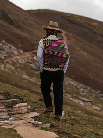 Man in traditional andean indigenous clothes at colorful Palccoyo rainbow mountain Palcoyo Cuzco Peru South Americaの写真素材