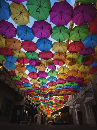 Panorama view of colorful umbrellas sky street decoration art installation in Cite Berryer Le Village Royal Paris Franceの写真素材