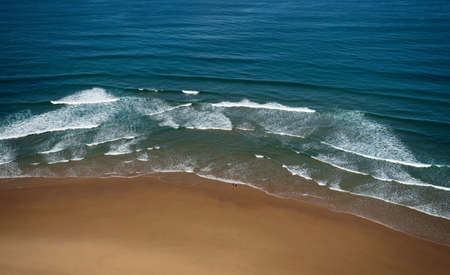 Aerial drone panorama of isolated surfer with surfboard on Praia da Cordoama beach idyllic nature...