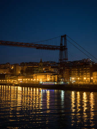 Illuminated Vizcaya transporter bridge in Getxo Portugalete over Nervion river Bilbao Basque Country...