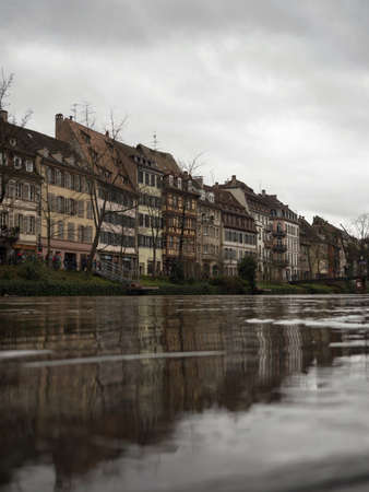 Charming picturesque old traditional architecture half-timbered houses buildings mirror water reflection at Ill Rhine river in Strasbourg Grand Est Bas Rhin Alsace, Petite France Europeの写真素材