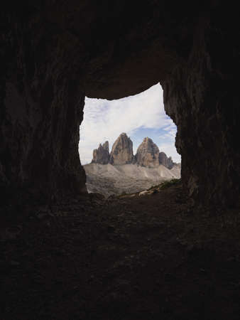 Cave window view of Tre Cime di Lavaredo peak summit alpine mountain panorama in Sexten Dolomites Belluno South Tyrol Italy alps Europeの写真素材