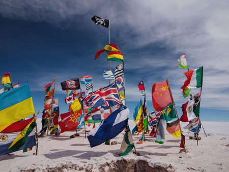 Panorama view of various different nation country flags from all over the world on Salar de Uyuni dry salt flat lake in Potosi, Bolivia South Americaの写真素材