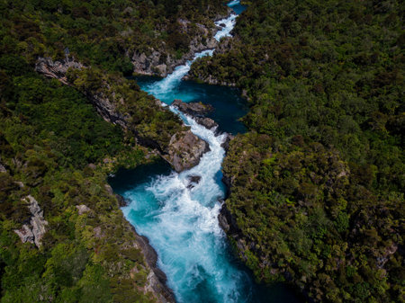 Aerial panorama of water flooded canyon Waikato river rapids surrounded by green nature forest at Aratiatia Dam near Lake Taupo North Island New Zealandの写真素材