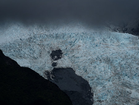 Detail closeup view of snow ice fields on Franz Josef Glacier Ka Roimata O Hine Hukatere on a cloudy...
