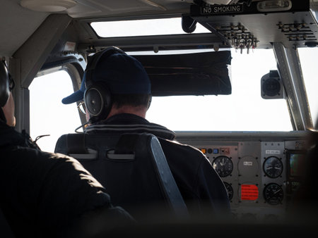 propeller aircraft pilot looking out the window with cockpit control panel dashboard dsiplay with...