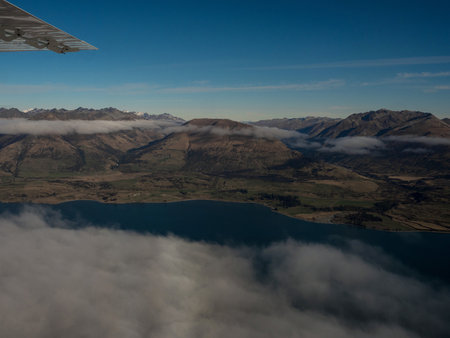 Airplane window seat panorama view of Lake Wakatipu alpine mountain landscape, Southern Alps, Glenorchy, Queenstown, Otago, South Island, New Zealandの写真素材