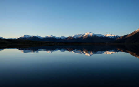 Lake Heron idyllic remote rural countryside golden hour winter sunset, Southern Alps mountain landscape at Ashburton Lakes Canterbury South Island New Zealandの写真素材
