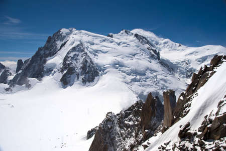 Mont Blanc as seen form the Aguille du Midi staion in summer, showing rocks, snow and high mountain landscapeの写真素材