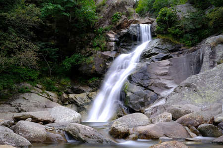 Small waterfall on an Italian stream, surrounded by natureの写真素材