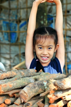 The girl behind the wood and lift her armsの写真素材