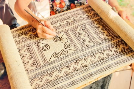Drawing a batik design on the fabricの写真素材