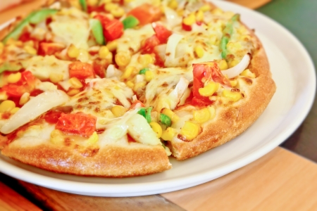 Normal pizza with fresh tomatoes,cornの写真素材